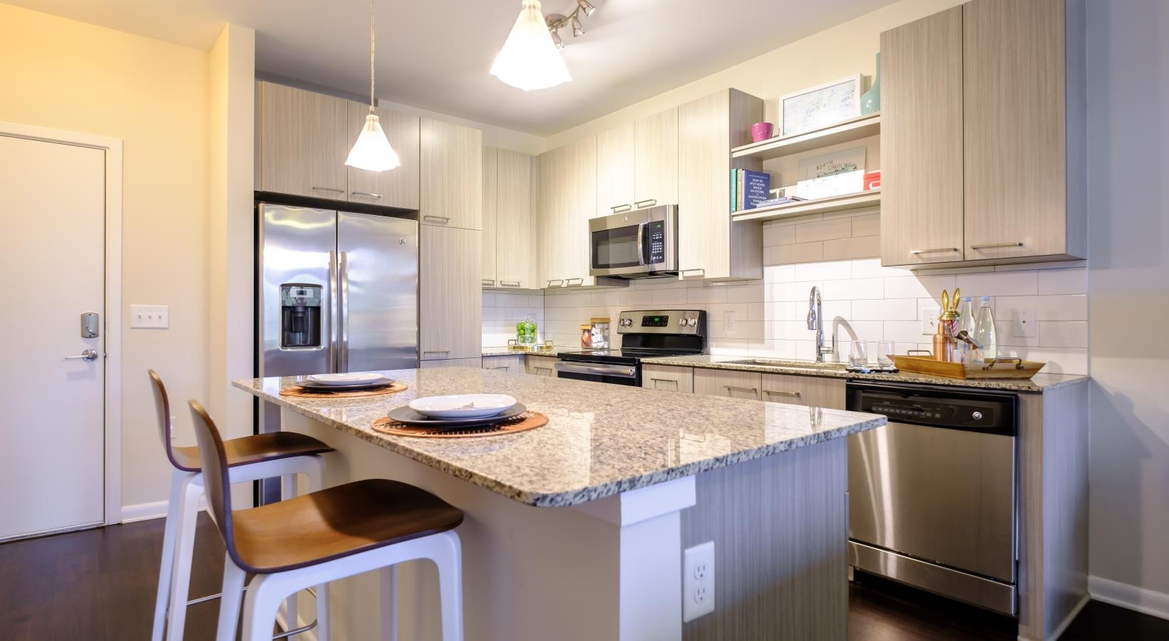 Beautiful kitchens with designer finishes a kitchen with an island and bar stools