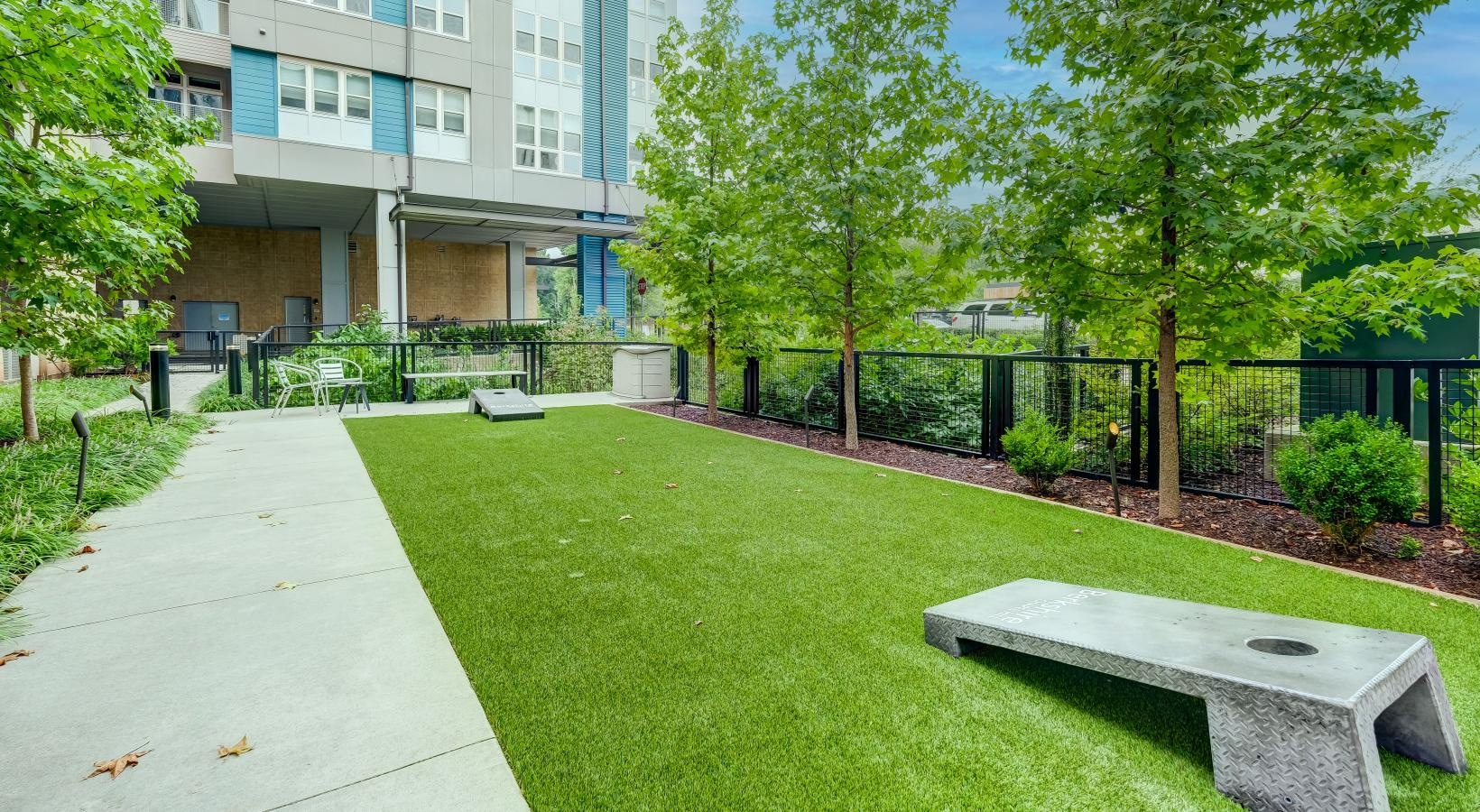 The essence of exceptional living courtyard with cornhole and trees
