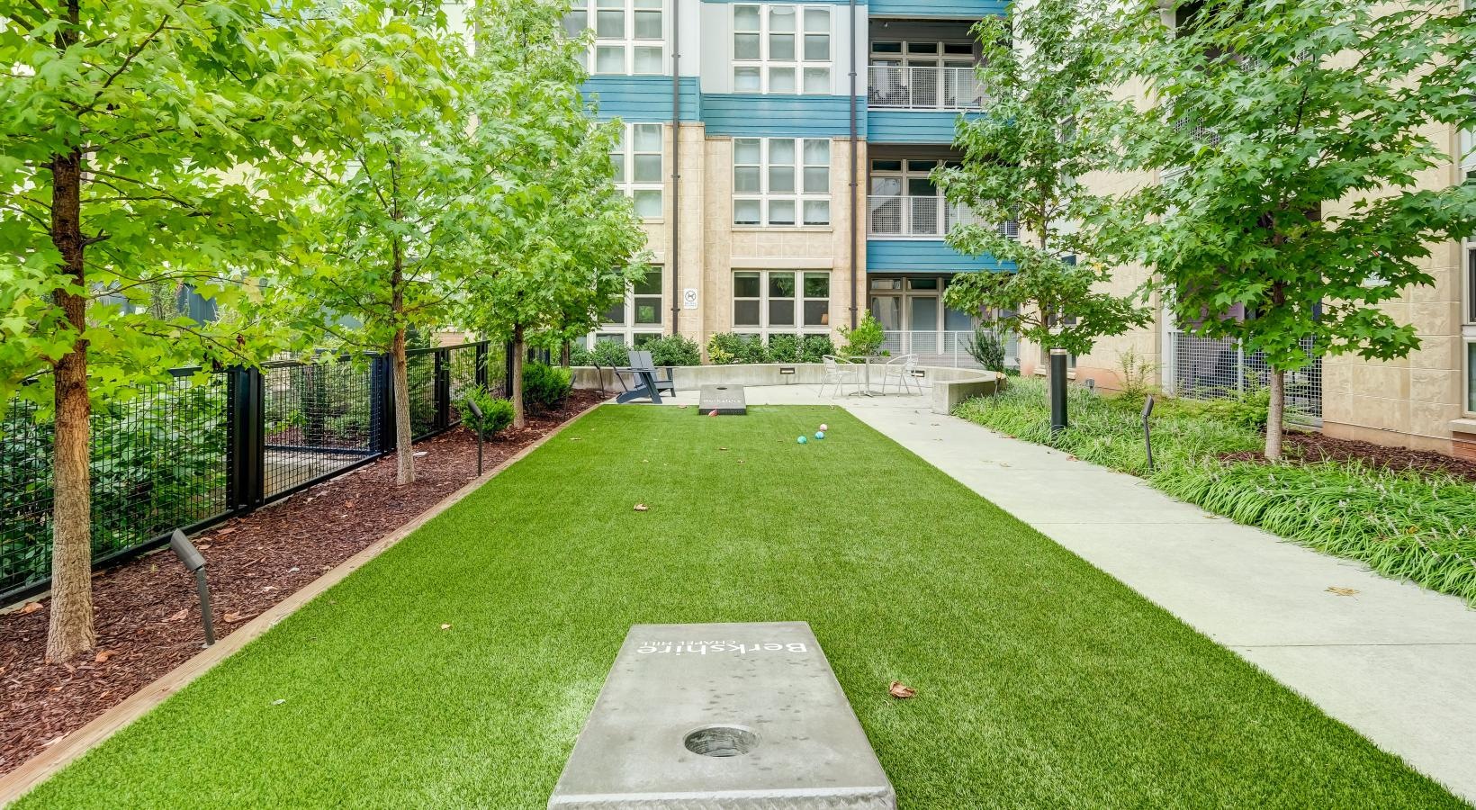 State-of-the-art amenities courtyard with cornhole area