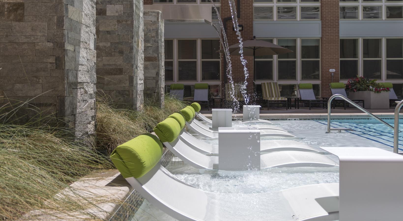 Sparkling swimming pool pool with lounge chairs