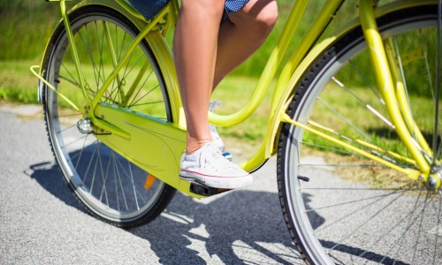 a person's legs on a bicycle