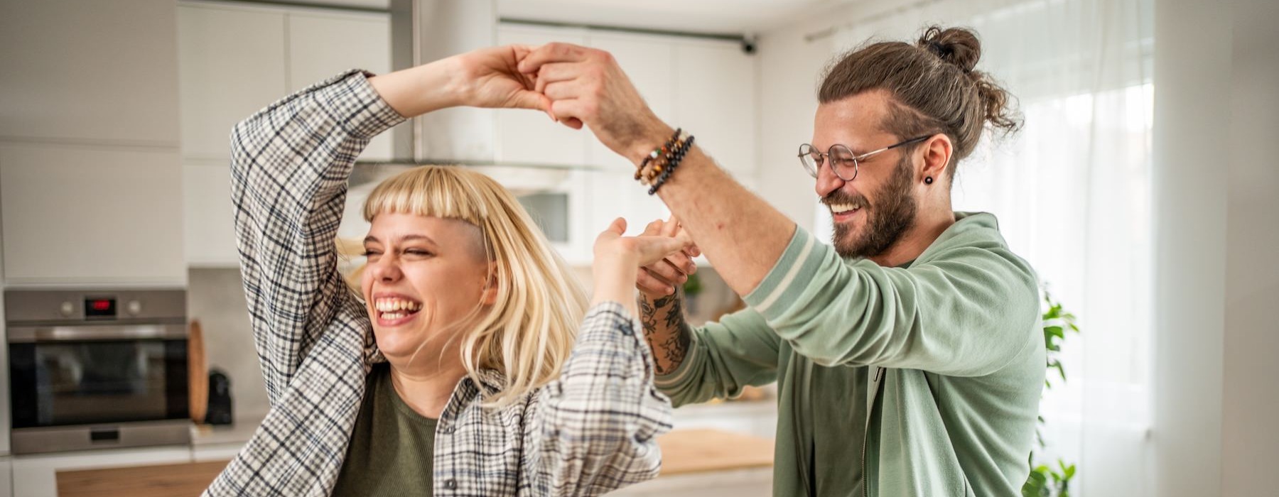 a couple dancing in a kitchen